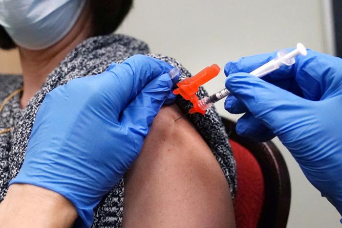 A woman receives a COVID-19 vaccine injection.