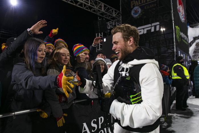 Gus Kenworthy greets friends and fans at the base of the superpipe in Aspen, Colo.