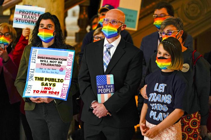 People gather to protest against HB1041, a bill to ban transgender women and girls from participating in school sports that match their gender identity, during a rally at the Statehouse in Indianapolis.