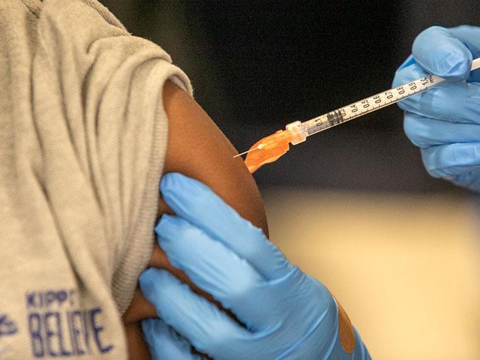 Medical personnel vaccinate students at KIPP Believe Charter School in New Orleans, Tuesday, Jan. 25, 2022