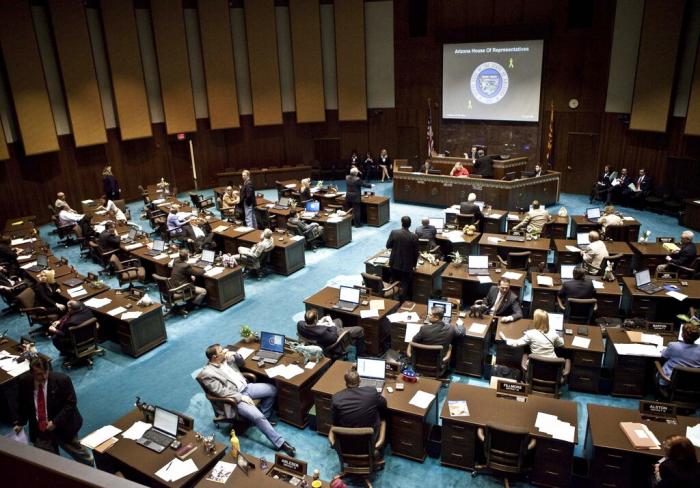 The Arizona House of Representatives gather during a legislative session Wednesday, April 6, 2011, at the Capitol in Phoenix.