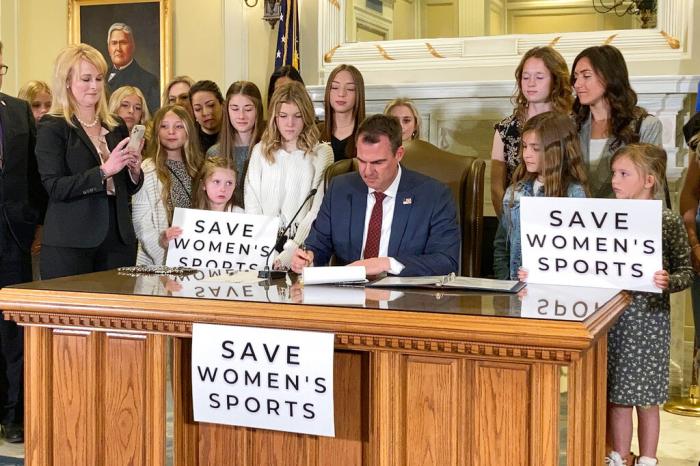 Oklahoma Gov. Kevin Stitt signs a bill in Oklahoma City on Wednesday, March 30, 2022, that prevents transgender girls and women from competing on female sports teams.