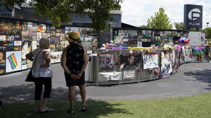 Visitors pay tribute to the display outside the Pulse nightclub memorial Friday, June 11, 2021, in Orlando, Fla.