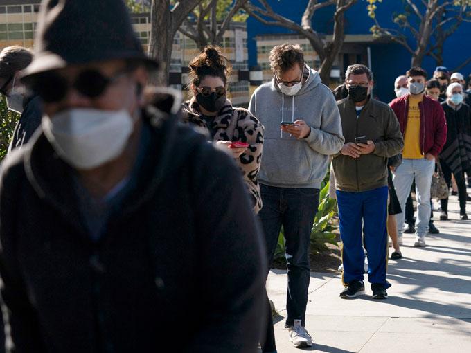 People wait in line for a COVID-19 test in Los Angeles, Tuesday, Jan. 4, 2022