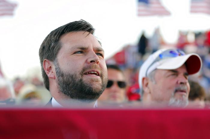 Senate candidate JD Vance listens to former President Donald Trump at a rally at the Delaware County Fairgrounds in Delaware, Ohio.