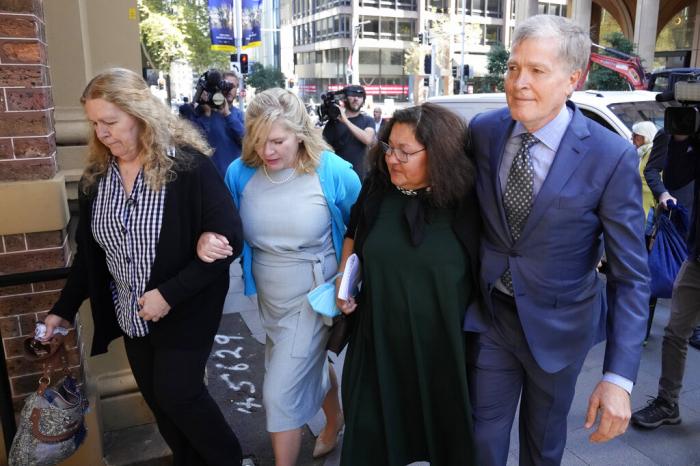 Steve Johnson, right, with his sisters, Terry, left, and Rebecca and his wife Rosemarie, second right, arrive at the Supreme Court in Sydney, Monday, May 2, 2022, for a sentencing hearing in the murder of Scott Johnson, Steve, Terry and Rebecca's brother.