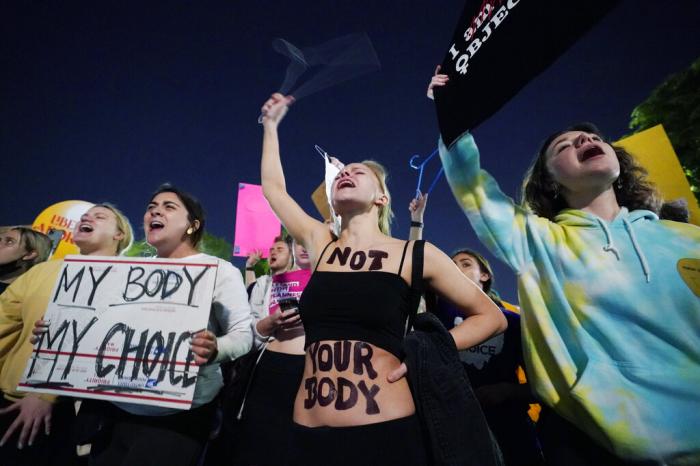 A crowd of people gather outside the Supreme Court, early Tuesday, May 3, 2022 in Washington.