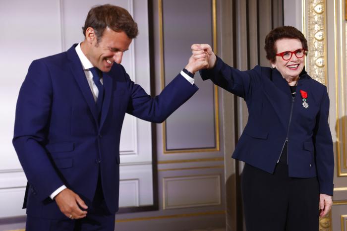 French President Emmanuel Macron holds the hand of tennis legend Billie Jean King, of the U.S, after she was awarded with the Legion d'Honneur at the Elysee Palace Friday in Paris.
