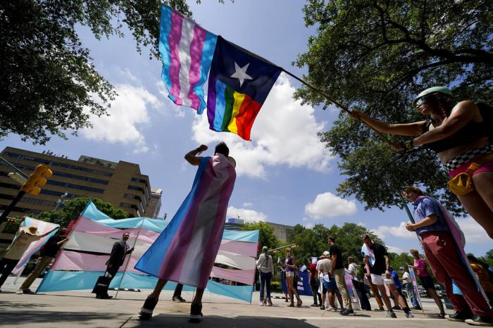 Demonstrators gather on the steps to the State Capitol to speak against transgender-related legislation bills being considered in the Texas Senate and Texas House.