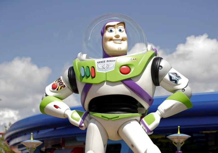 Character Buzz Lightyear stands near the entrance to the Aliens Swirling Saucers ride at Toy Story Land in Disney's Hollywood Studios at Walt Disney World.