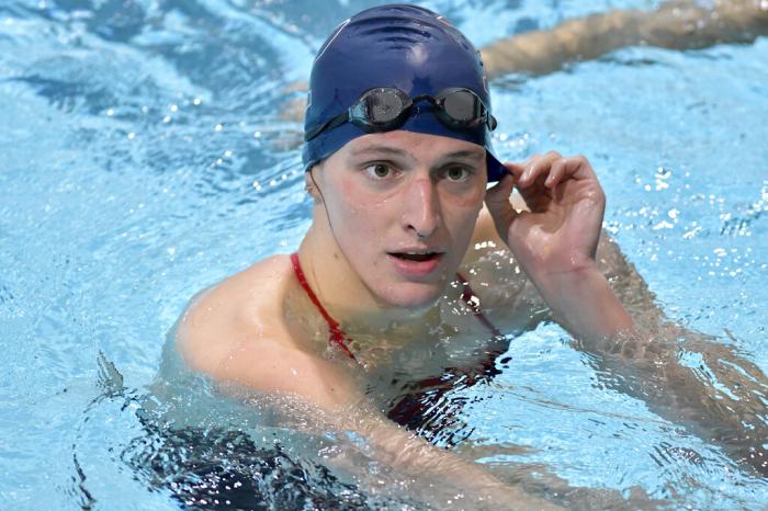 Transgender swimmer Lia Thomas speaks to her coach after winning the 500 meter freestyle during a meet with Harvard.