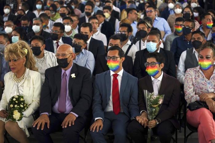 Couples of the same sex attend a mass wedding ceremony organized by city authorities as part of the LGBTQ pride month celebrations, in Mexico City.