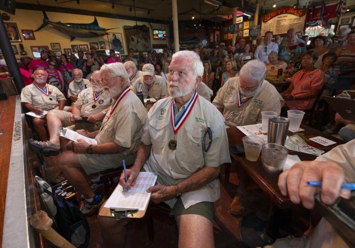 Tom Gizzard, center, the 2008 winner of the "Papa Hemingway Look-Alike Contest and other previous winners/judges examine contestants during the first round of the 2022 contest.