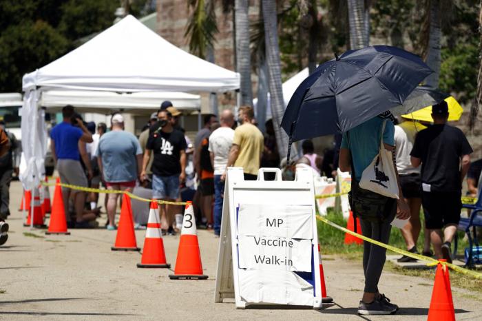 People line up at a monkeypox vaccination site on Thursday, July 28, 2022, in Encino, Calif.