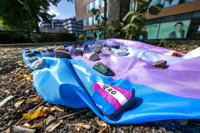 People have laid out a flag weighted down with painted stones in Muenster, Germany.