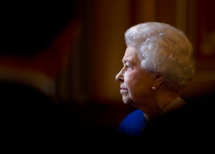 Britain's Queen Elizabeth II escorted by British Foreign Secretary William Hague, unseen, tours The Foreign and Commonwealth Office.