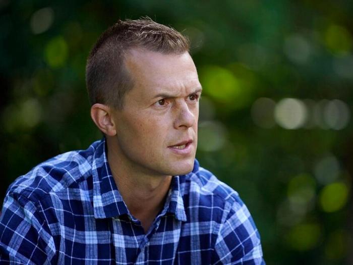 U.S. Rep. Jared Golden, D-Maine, speaks to a reporter at his home, Thursday, Sept. 1, 2022, in Lewiston, Maine. Golden is being challenged by Republican Bruce Poliquin in the November election. (AP Photo/Robert F. Bukaty)