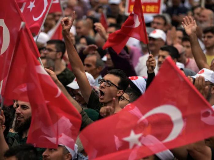 Turkish demonstrators chant slogans while holding Turkish flags during a anti LGBTI+ protest, in Fatih district of Istanbul, Sunday, Sept. 18, 2022. (AP Photo/Khalil Hamra)
