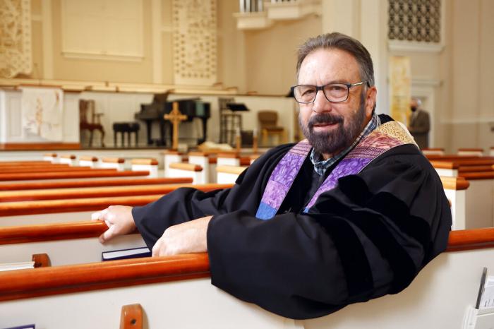 Pastor Mike Usey poses for a portrait sitting in the pews of College Park Baptist Church in Greensboro, N.C.