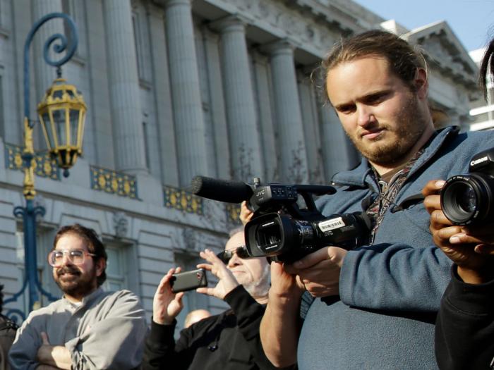 David DePape, right, records the nude wedding of Gypsy Taub outside City Hall on Dec. 19, 2013, in San Francisco. 