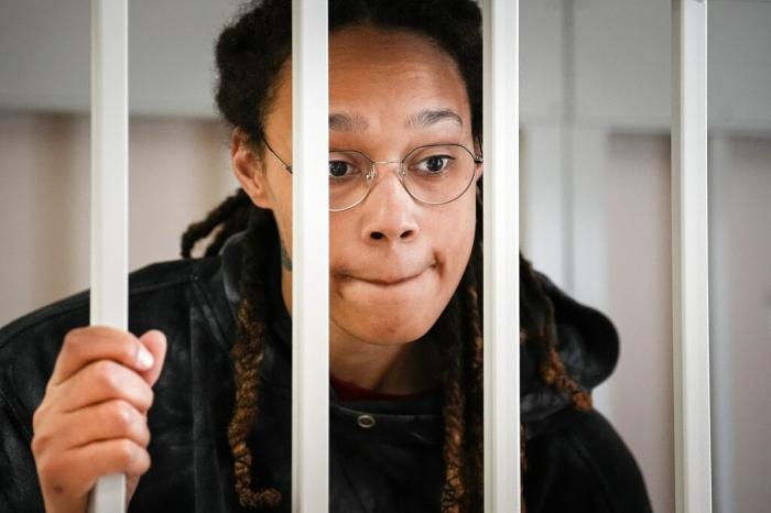 WNBA star and two-time Olympic gold medalist Brittney Griner speaks to her lawyers standing in a cage at a court room prior to a hearing, in Khimki just outside Moscow, Russia.