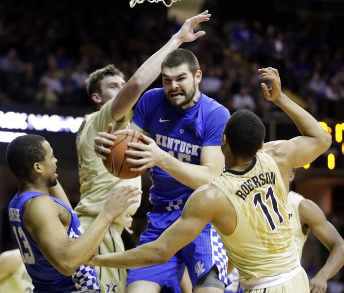 Kentucky forward Isaac Humphries, center, grabs a rebound in front of Vanderbilt's Luke Kornet, second from left, and Jeff Roberson (11) during the first half of an NCAA college basketball game on Jan. 10, 2017, in Nashville, Tenn.