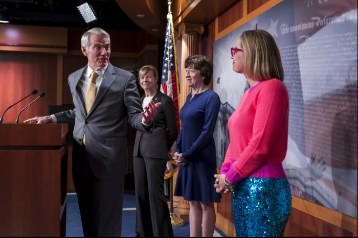From left, Sen. Rob Portman, R-Ohio, Sen. Tammy Baldwin, D-Wis., Sen. Susan Collins, R-Maine, and Sen. Kyrsten Sinema, D-Ariz., talk with reporters following Senate passage of the Respect for Marriage Act, at the Capitol in Washington.
