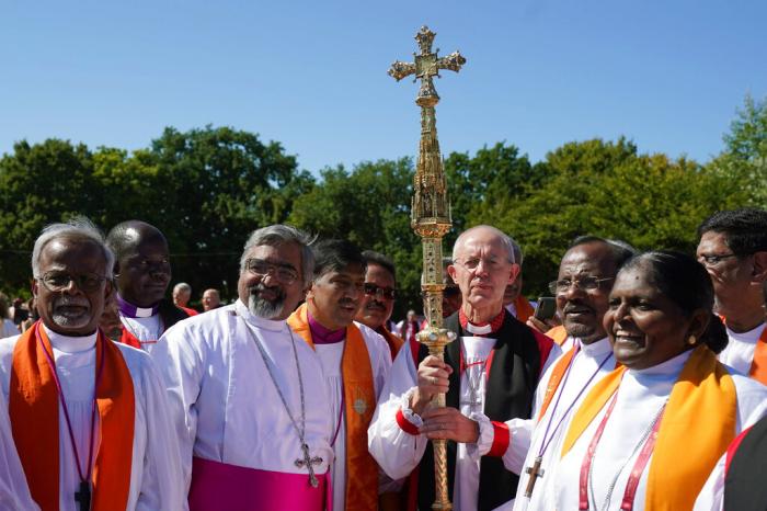 Archbishop of Canterbury Justin Welby, center right and bishops from around the world gather at the University of Kent for a group photo during the 15th Lambeth Conference, in Canterbury, England, Friday, July 29, 2022. 