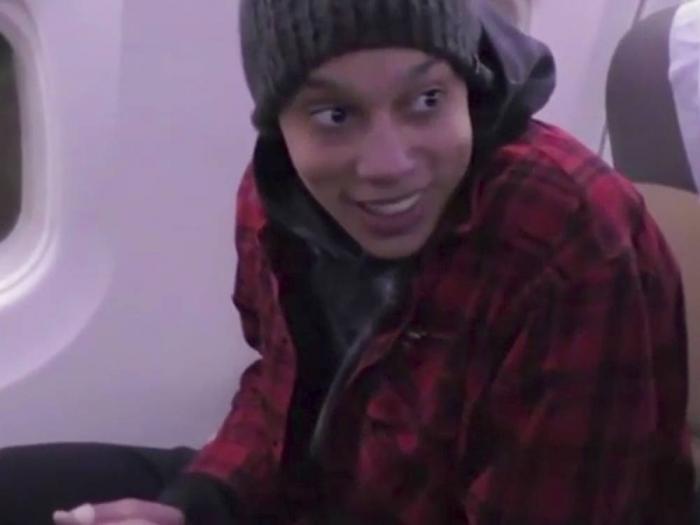 In this image made from video provided by Russian Federal Security Service, WNBA star and two-time Olympic gold medalist Brittney Griner sits in the plane as she flies to Abu Dhabi to be exchanged for Russian citizen Viktor Bout, in Russia, Friday, Dec. 9, 2022. (Russian Federal Security Service via AP)