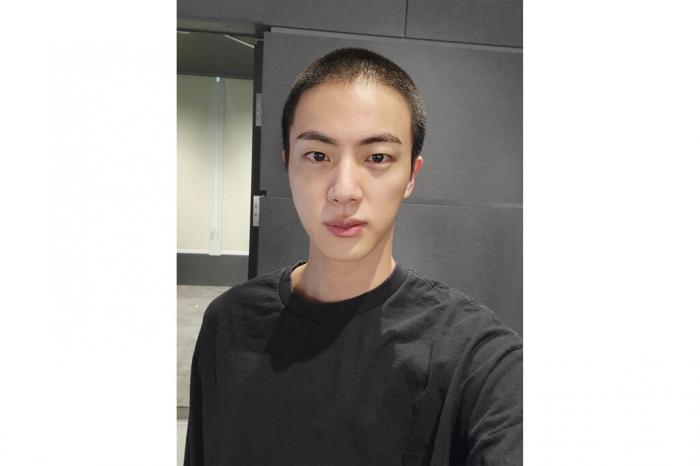 Jin of K-pop band BTS shows off freshly shaved hair on the K-pop social media platform Weverse, which was uploaded Sunday, Dec. 11, 2022, ahead of his upcoming military conscription. 