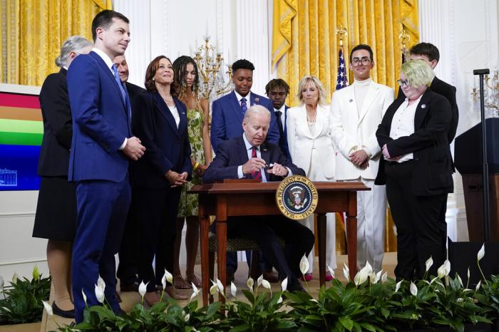 President Joe Biden signs an executive order at an event to celebrate Pride Month in the East Room of the White House, June 15, 2022, in Washington. 