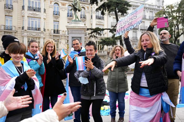 People react outside the parliament after the new Transgender Law was announced in Madrid, Spain, Thursday, Dec. 22, 2022.
