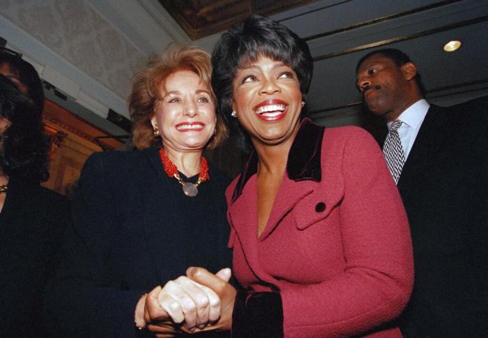Oprah Winfrey is greeted by Barbara Walters, left, as she arrives at New York's Plaza Hotel, Nov. 11, 1994. 