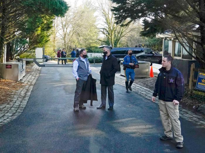 Security personnel stand at the entrance to President Joe Biden and first lady Jill Biden's home in Wilmington, Del., on Feb. 21, 2021. 
