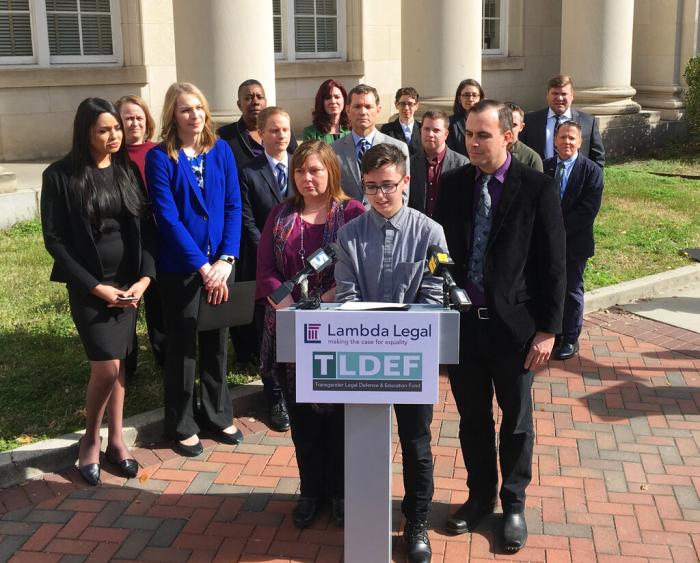 Connor Thonen-Fleck addresses reporters while his parents stand by his side on March 11, 2019, in Durham, N.C., at the announcement of a lawsuit against North Carolina officials over how the state health plan is run. 