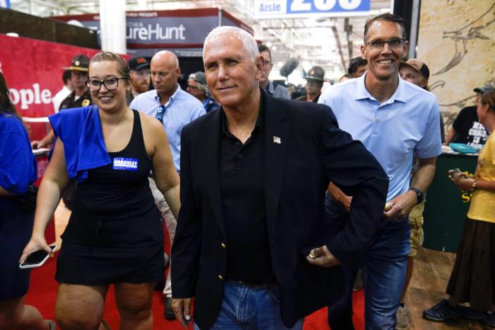 Former Vice President Mike Pence walks through the Varied Industries Building during a visit to the Iowa State Fair, Friday, Aug. 19, 2022, in Des Moines, Iowa.