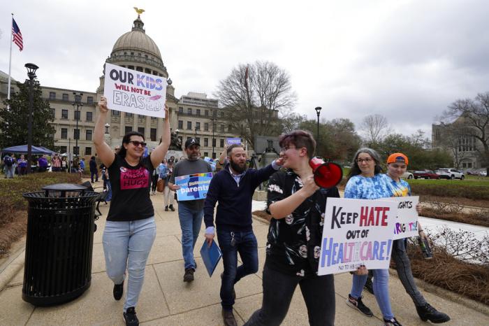 Leviathan Myers-Rowell, right, looks back at his mother Jodi Rowell, left, and calls out to her as he leads a march of transgender youth, their families and supporters from the Mississippi Capitol in Jackson, Wednesday, Feb. 15, 2023. 