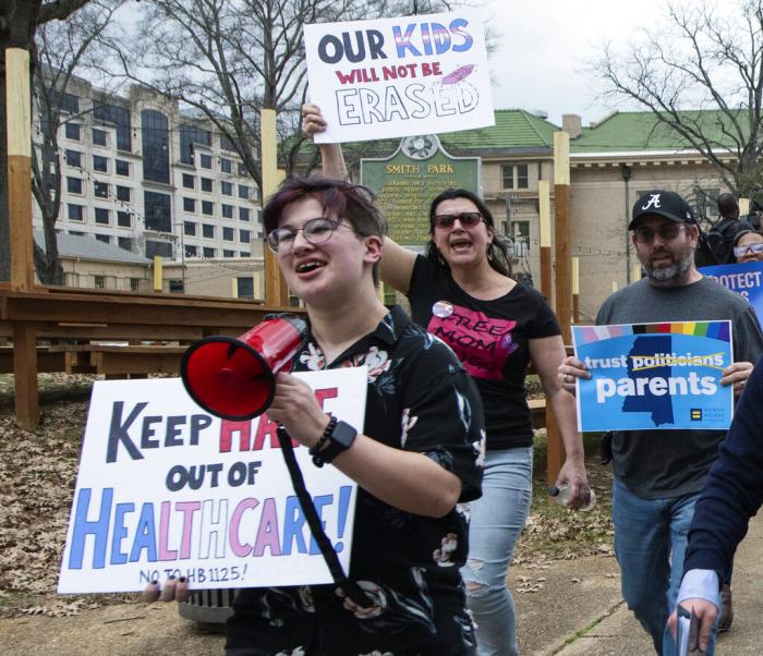 Leviathan Myers-Rowell, 16, from left, of Ocean Springs, Miss., and his parents Jodi and Thomas Rowell march from the state Capitol toward the governor's mansion following a rally at the Capitol in support of transgender youth and in opposition to House Bill 1125 in Jackson, Miss.
