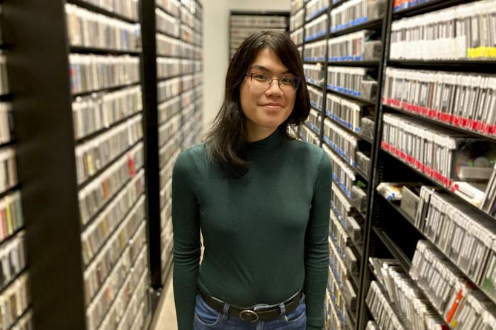 Maia Xiao poses for a portrait in the library of radio station KEXP where she volunteers in Seattle, Feb. 17, 2023. 