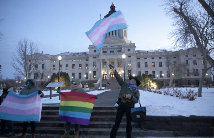 A group of LGBTQ advocates gathere outside the South Dakota Capitol in Pierre on Jan. 26, 2021, to protest a bill that would have banned people from updating the sex on their birth certificates.