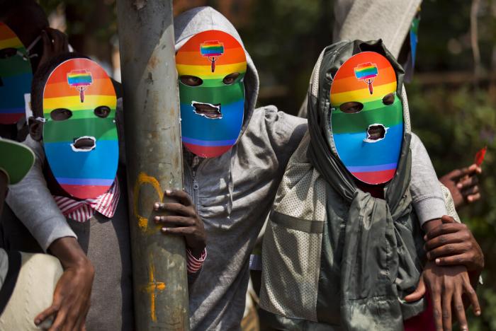 Kenyan gays and lesbians and others supporting their cause wear masks to preserve their anonymity as they stage a rare protest, against Uganda's tough stance against homosexuality and in solidarity with their counterparts there, outside the Uganda High Commission in Nairobi, Kenya, Feb. 10, 2014.