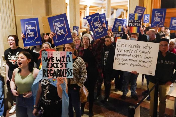 Protesters stand outside of the Senate chamber at the Indiana Statehouse, Wednesday, Feb. 22, 2023, in Indianapolis.