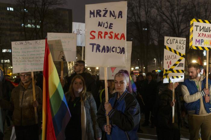 People hold banners as they attend a LGBTQ rights protest in central in Belgrade, Serbia, Friday, March 3, 2023.