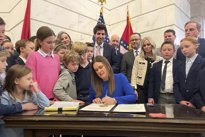 Arkansas Gov. Sarah Huckabee Sanders signs into law an education overhaul bill on Wednesday, March 8, 2023 at the state Capitol in Little Rock, Ark.