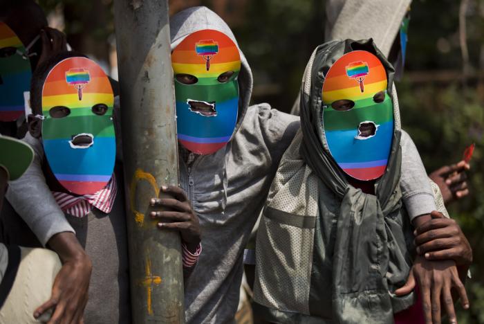 Kenyan gays and lesbians and others supporting their cause wear masks to preserve their anonymity as they stage a rare protest against Uganda's tough stance against homosexuality and in solidarity with their counterparts there, outside the Uganda High Commission in Nairobi, Kenya on Feb. 10, 2014.