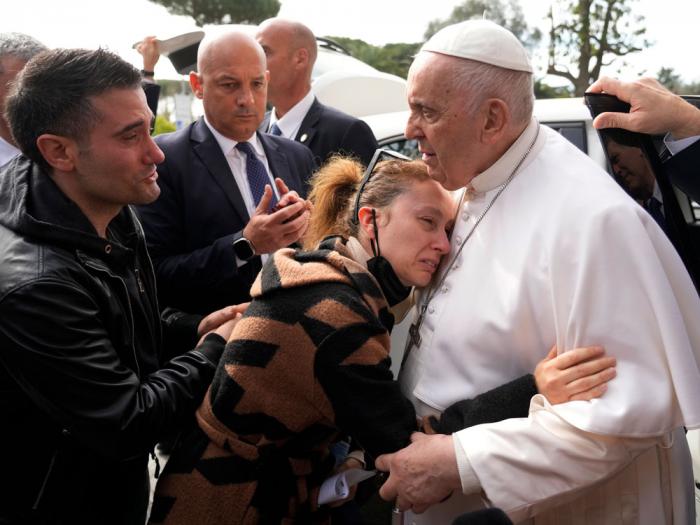 Pope Francis consoles Serena Subania and Matteo Rugghia, left, who lost their 5-year-old daughter Angelica yesterday, as he leaves the Agostino Gemelli University Hospital in Rome, Saturday, April 1, 2023, after receiving treatment for bronchitis