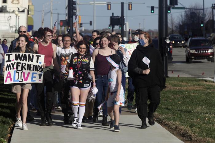 More than 100 people, many of them transgender youth, march around the Kansas Statehouse on the annual Transgender Day of Visibility, Friday, March 31, 2023, in Topeka, Kan. 