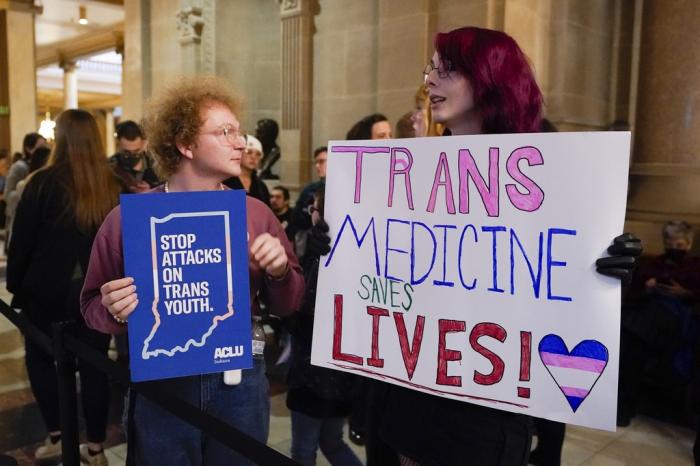 Protesters stand outside of the Senate chamber at the Indiana Statehouse on Feb. 22, 2023, in Indianapolis. 