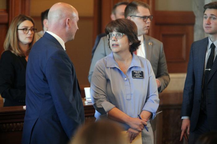 Kansas House Education Committee Chair Adam Thomas, left, R-Olathe, confers with Rep. Susan Estes, R-Wichita, during a debate on a bill that would allow parents to opt their children out of public-school lessons and activities with LGBTQ themes, Thursday, April 6, 2023, at the Statehouse in Topeka, Kan.