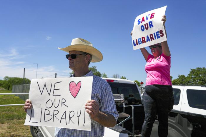 Llano, Texas resident, Emily Decker, right, and Llano County resident Michael McDavid, left, protest outside a Llano County Commissioner's Court meeting at the Llano County Law Enforcement Center on Thursday, April 13, 2023 in Llano, Texas. 